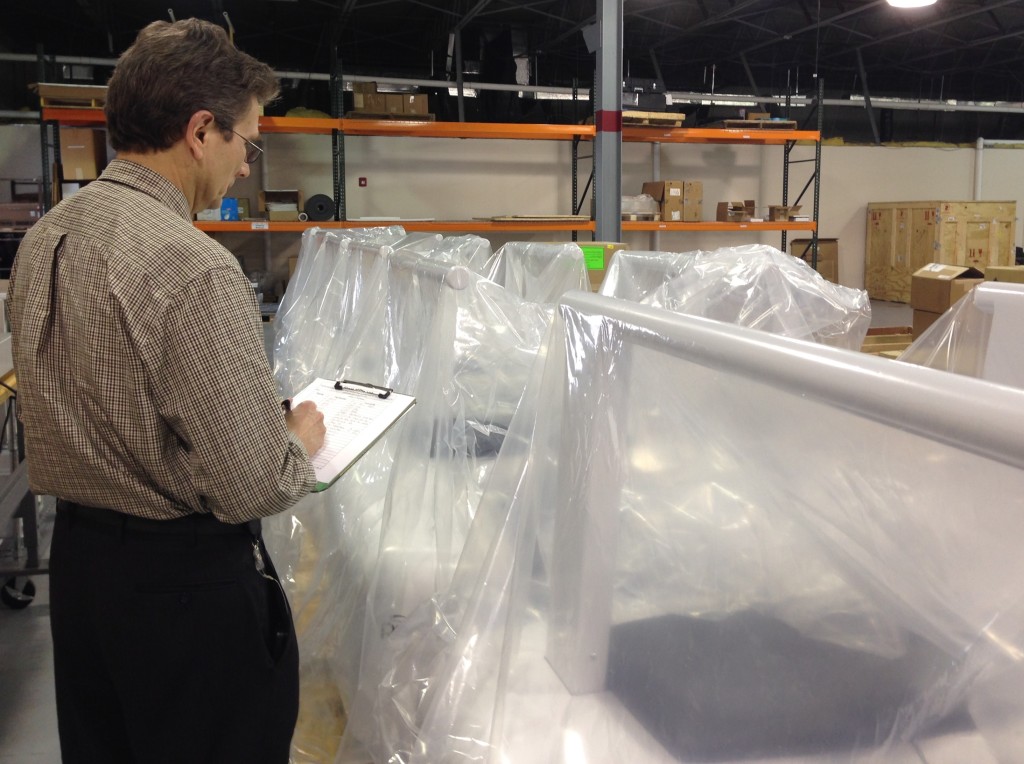 An engineer surveys inventory at CurveBeam headquarters. 